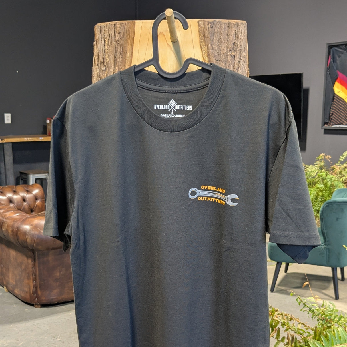 Front of tee showing small wrench on left top side with small logo of Overland Outfitters