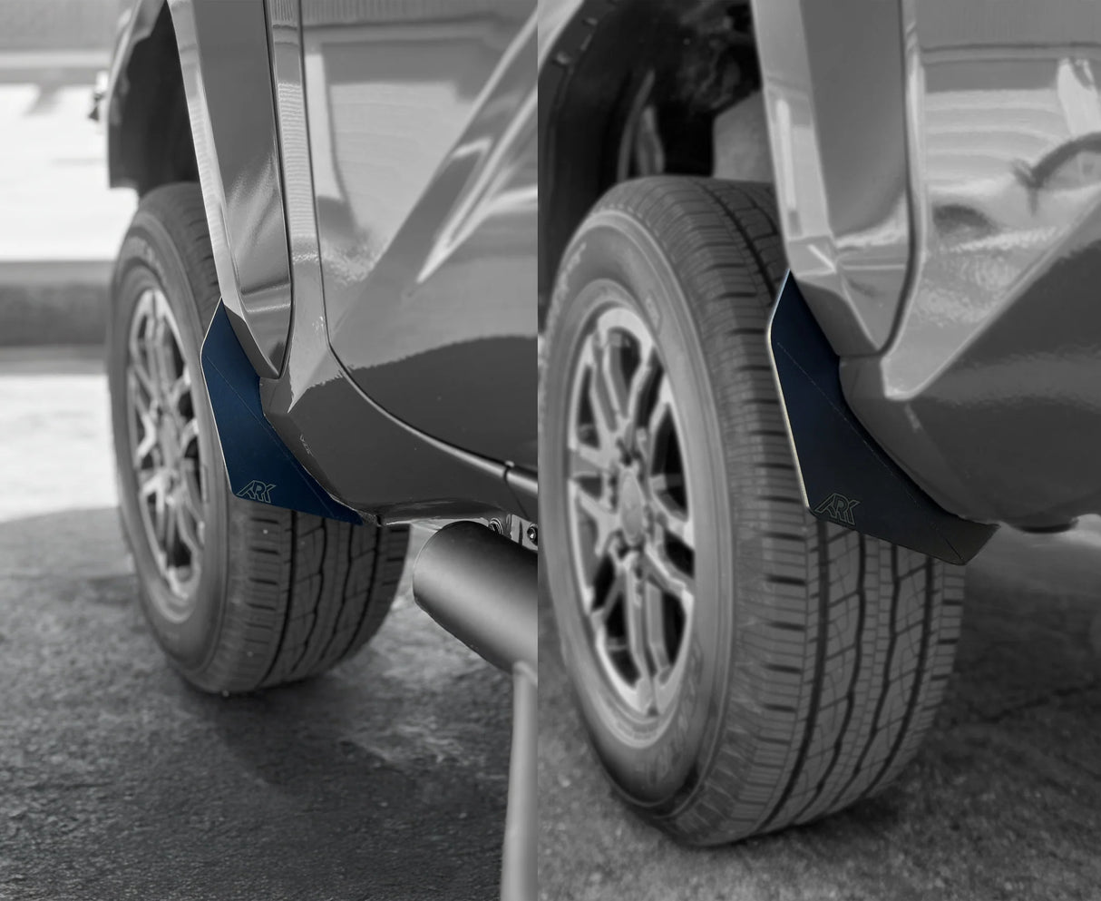 Close-up of vehicle mud flaps on a car tire with a blurred background