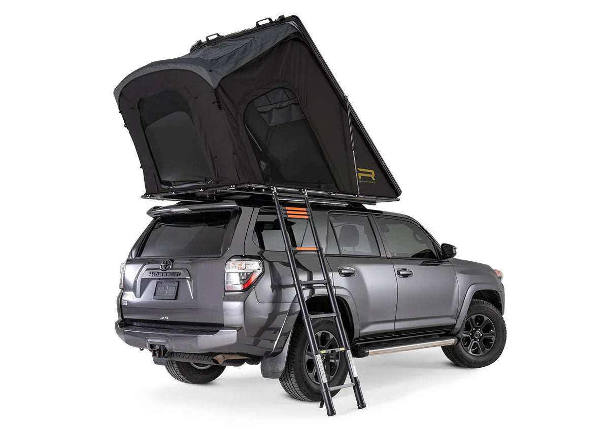 Gray SUV with a rooftop tent and ladder on a white background