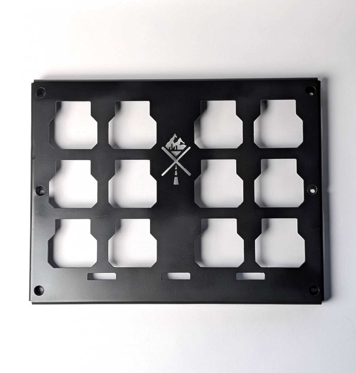 Black metal panel with cut-out shapes on a white background