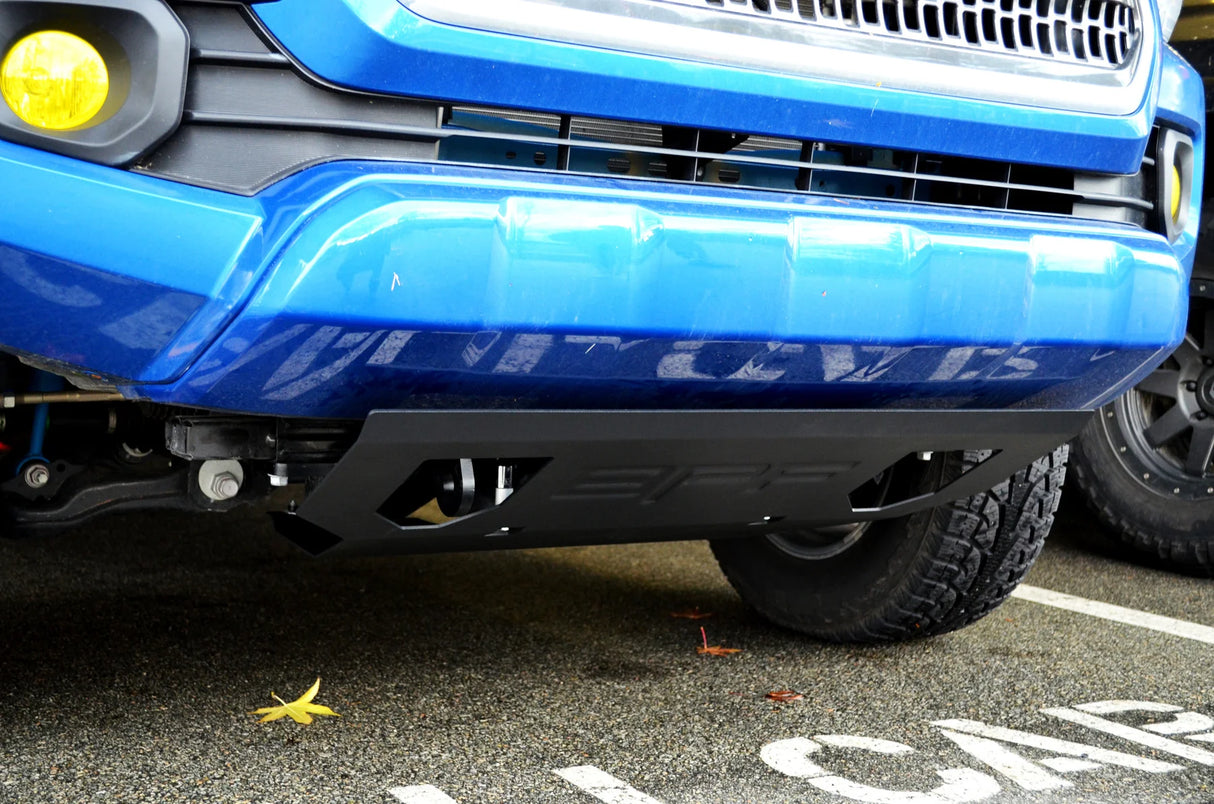Close-up of a blue vehicle's front bumper with a visible license plate area.