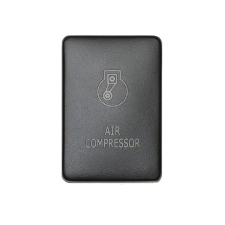 Front facing small air compressor switch in front of white backdrop