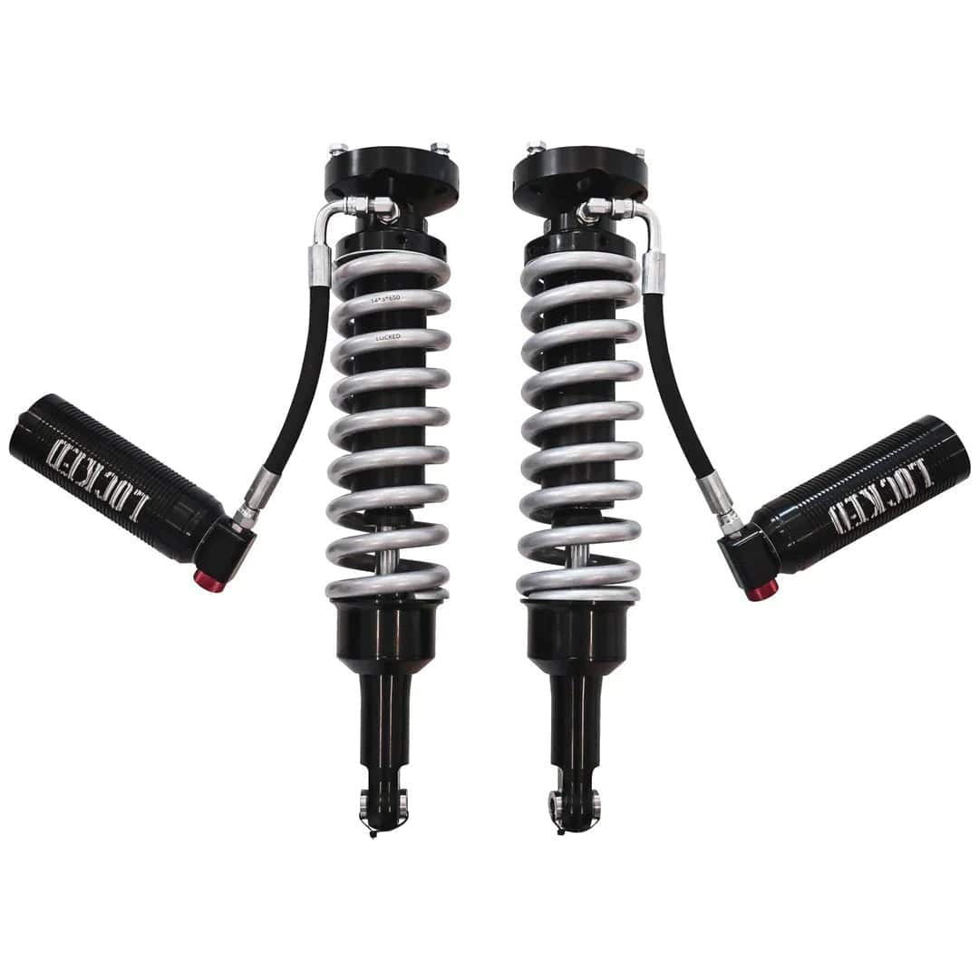 Two shock absorbers with springs on a white background