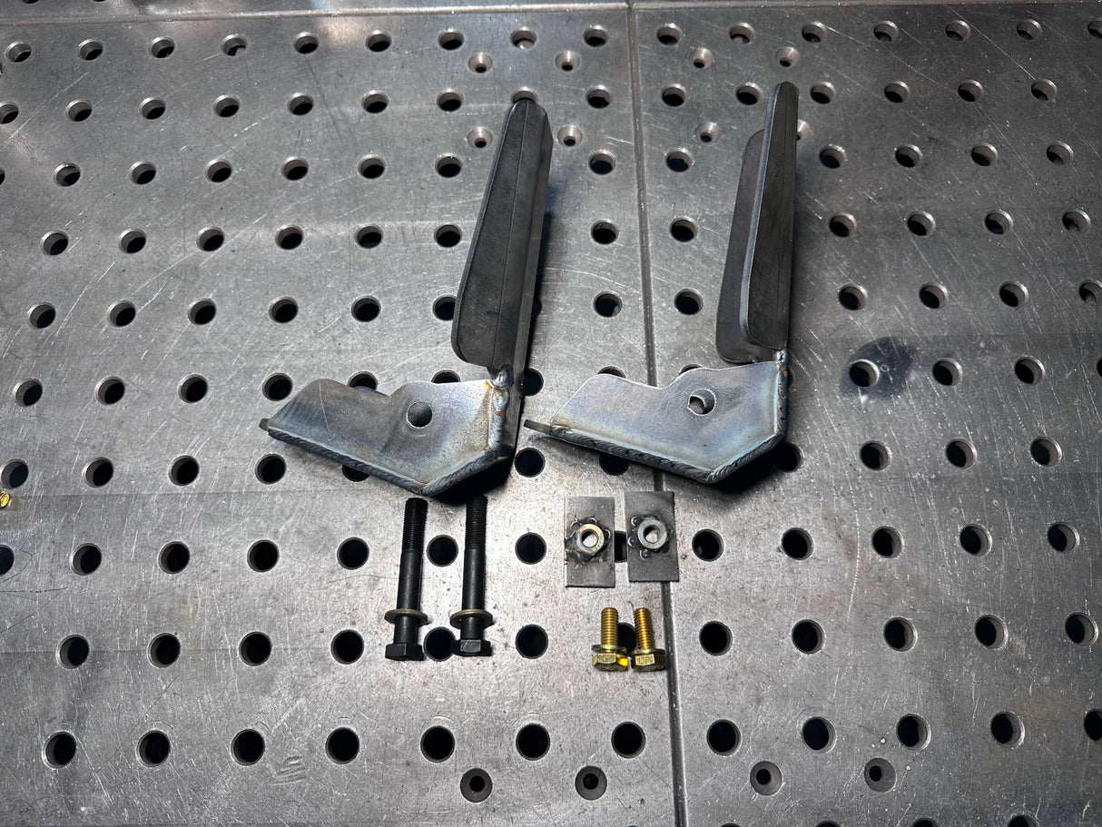 Metal brackets and screws on a perforated metal surface