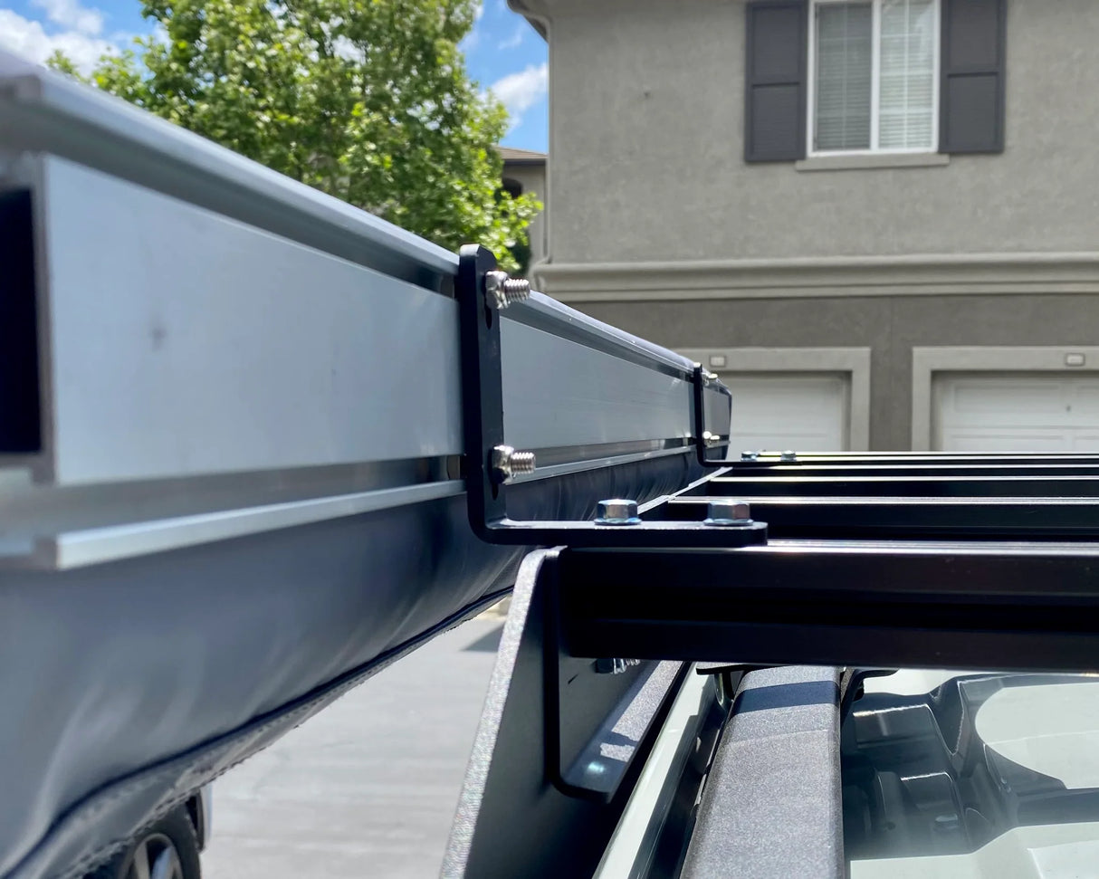 Close-up of a truck bed with a metal rack attached, outdoors.