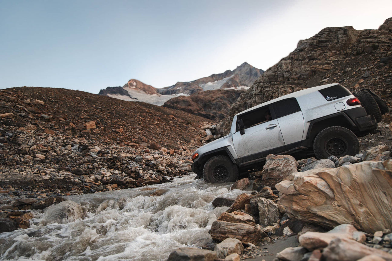 Angled side view of a khaki green coloured Toyota Fj Cruiser