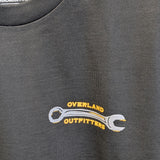 Close up of front graphic small wrench with Overland Outfitters surrounding it