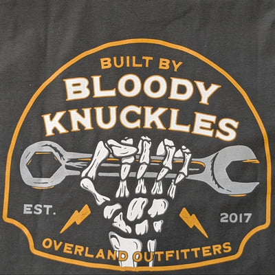 Close up of back graphic with skeleton hand clenching wrench