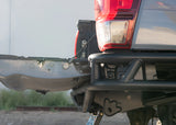 Close-up of a vehicle's rear bumper and tail light with a blurred background