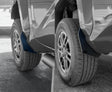 Close-up of car mud flaps on a vehicle with a blurred background