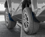 Close-up of vehicle mud flaps on a car tire with a blurred background