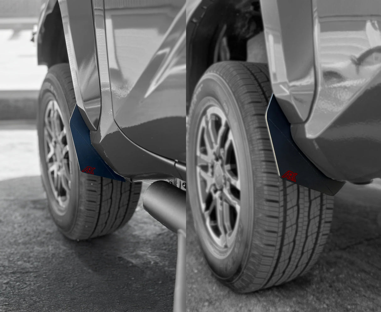 Close-up of a car's wheel and fender with a focus on the tire and mud flap.
