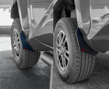 Close-up of a car's wheel and fender with a focus on the tire and mud flap.
