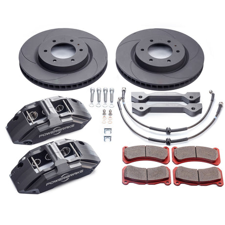 A set of black off-road brake calipers with a billet design, accompanied by high-performance brake pads and stainless steel braided brake lines.