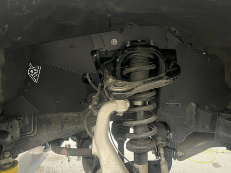 Close-up of a vehicle's suspension system with a visible brand logo.