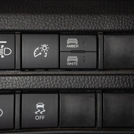 close up of car dash showing dual function square switch