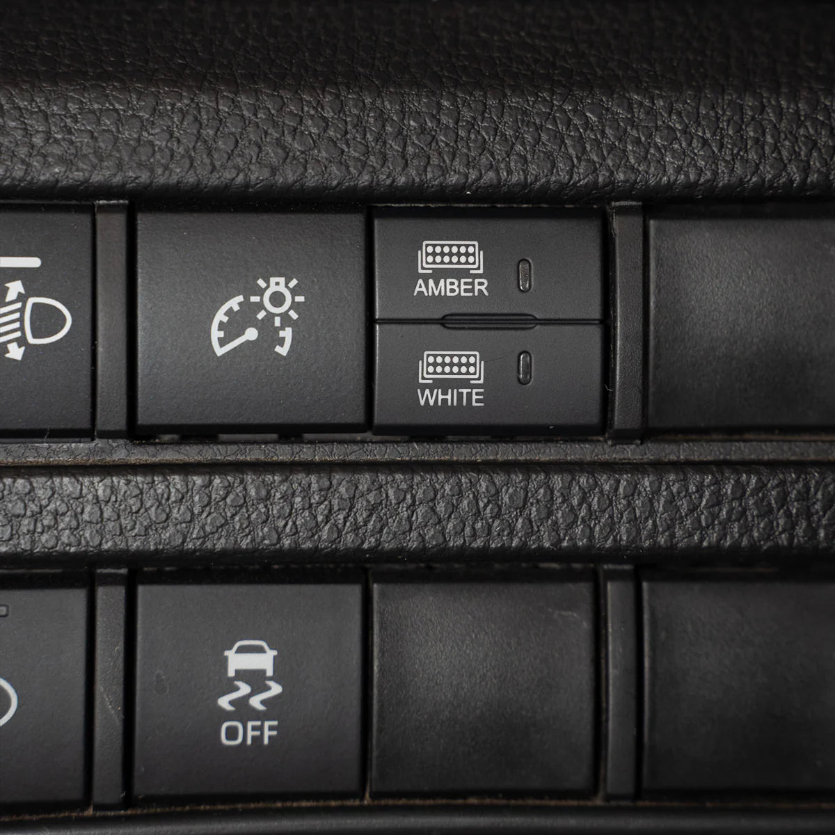 close up of car dash showing dual function square switch