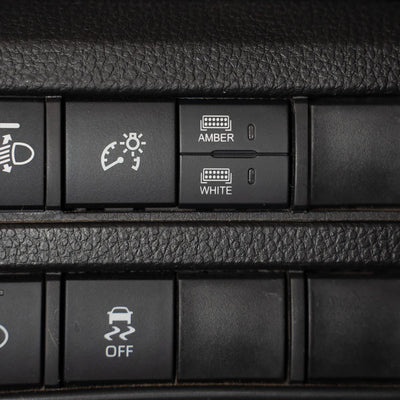 close up of car dash showing dual function square switch