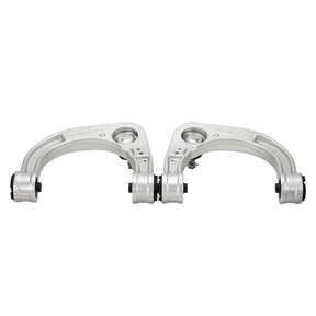 Two metal suspension control arms on a white background