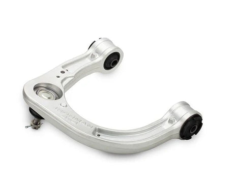 Silver metal control arm on a white background