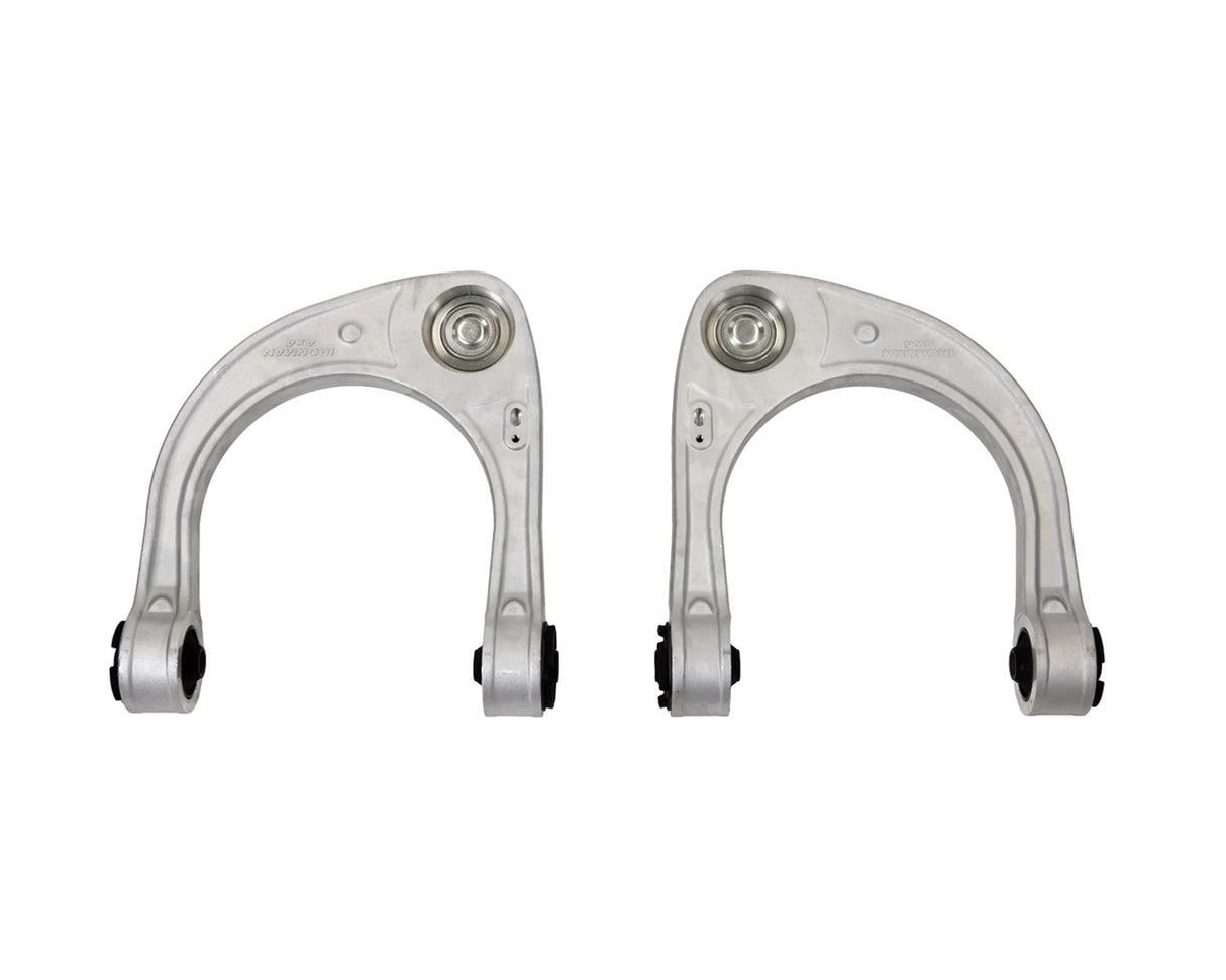 Two metallic control arms on a white background