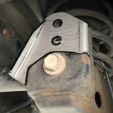 Rust-covered metal bracket with a bolt in an industrial setting