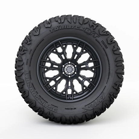 Black tire with a detailed tread pattern on a white background