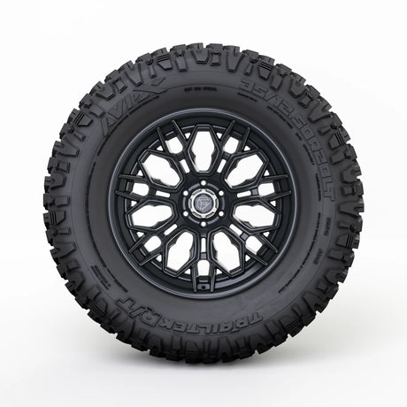 Black off-road tire with a detailed tread pattern on a white background
