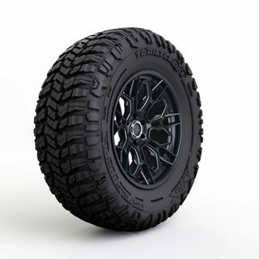 Black tire with tread pattern on a white background