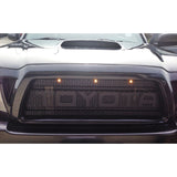 Front view of a Toyota car with illuminated logo