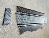Metal grating samples on a concrete floor