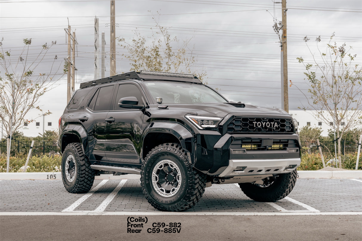 Black Toyota SUV with lifted suspension on a road