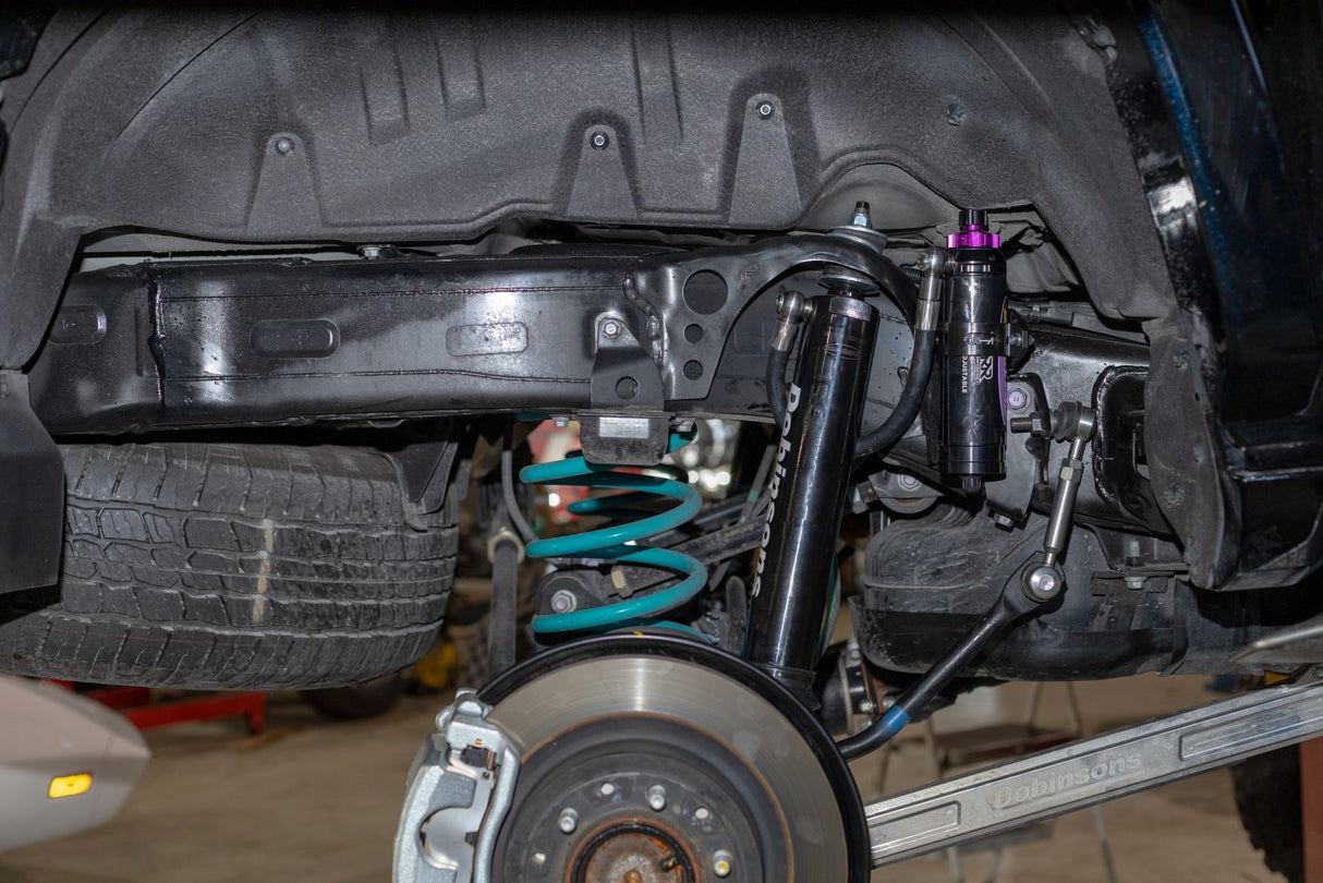 Close-up of a vehicle's undercarriage with suspension components.