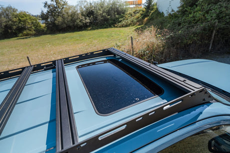 Top view of roof rack on SUV showing sunroof