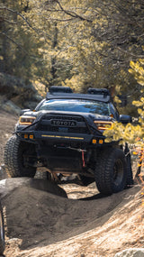 Toyota truck on a dirt trail in a forest