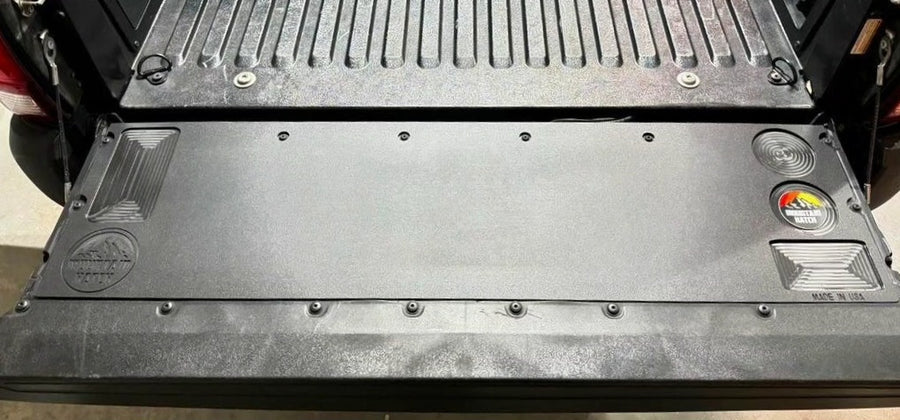 Close-up of a black metal mat in a vehicle's cargo area
