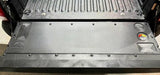 Close-up of a black metal mat in a vehicle's cargo area