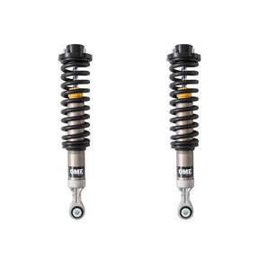 Black, silver and yellow OME coilovers on a white background