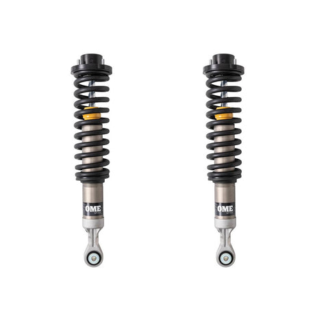 Black, silver and yellow OME coilovers on a white background