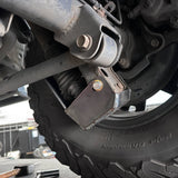 Close-up of a vehicle suspension system with a tire and wheel.