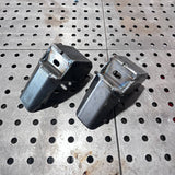 Two metal components on a perforated metal surface
