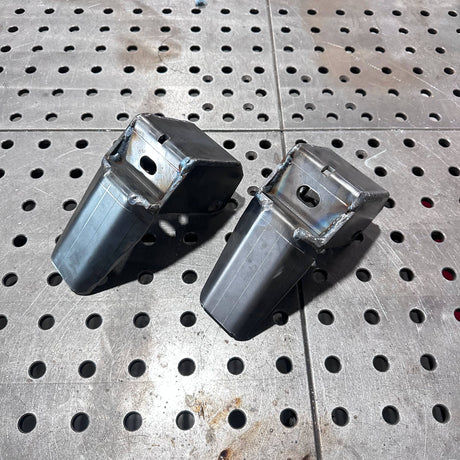 Two metal components on a perforated metal surface