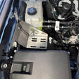 Close-up of a car's engine compartment with various components.