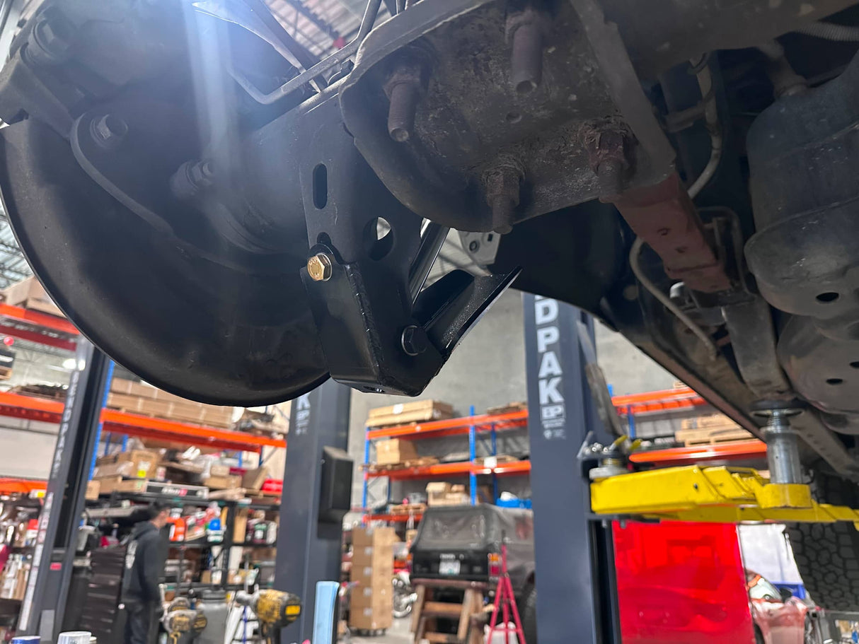 Close-up of a vehicle's undercarriage in a warehouse setting