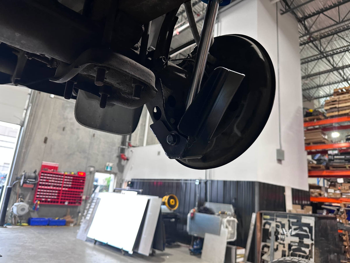 Close-up of a vehicle's undercarriage in a warehouse setting