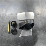 Mechanical parts including a metal bracket, bolts, and washers on a metallic surface.