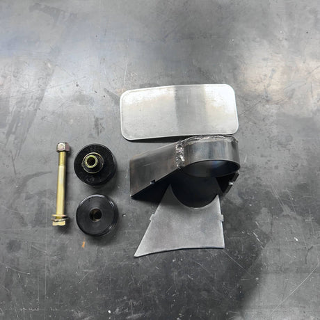 Mechanical parts including a metal bracket, bolts, and washers on a metallic surface.