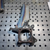 Metal engine part on a pegboard background
