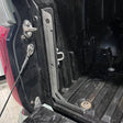 Close-up of a vehicle's open cargo area with tools and equipment inside.