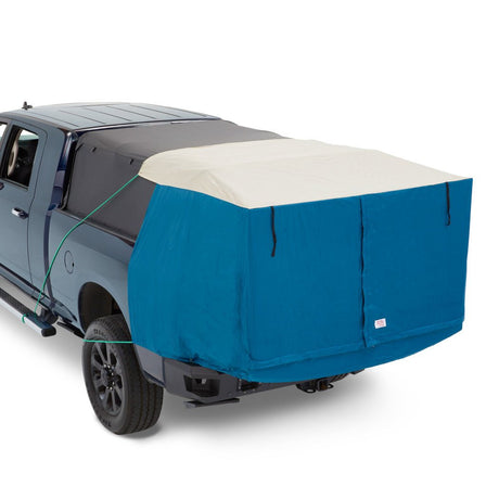 Blue truck bed cover on a gray truck with a white background
